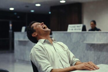 A man laughing in a bank in Sweden