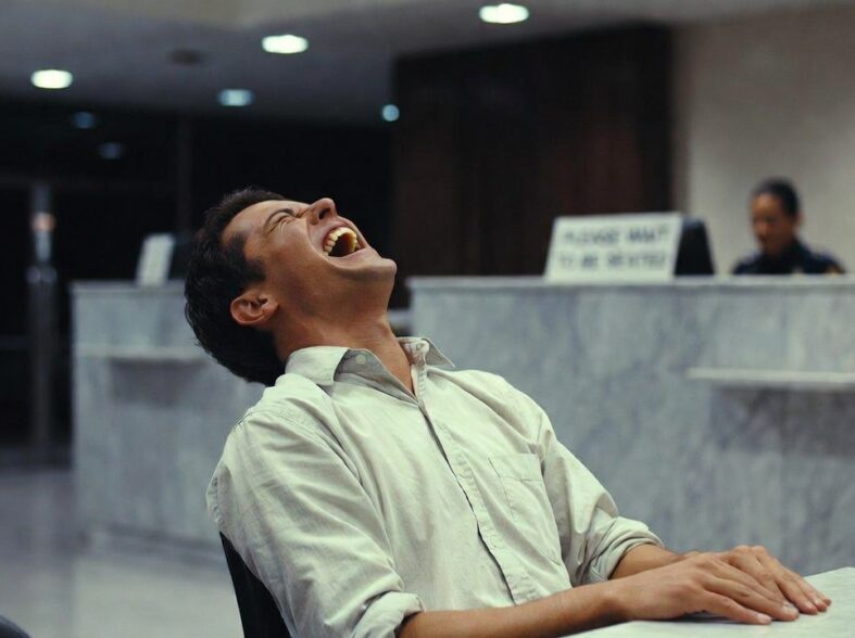 A man laughing in a bank in Sweden